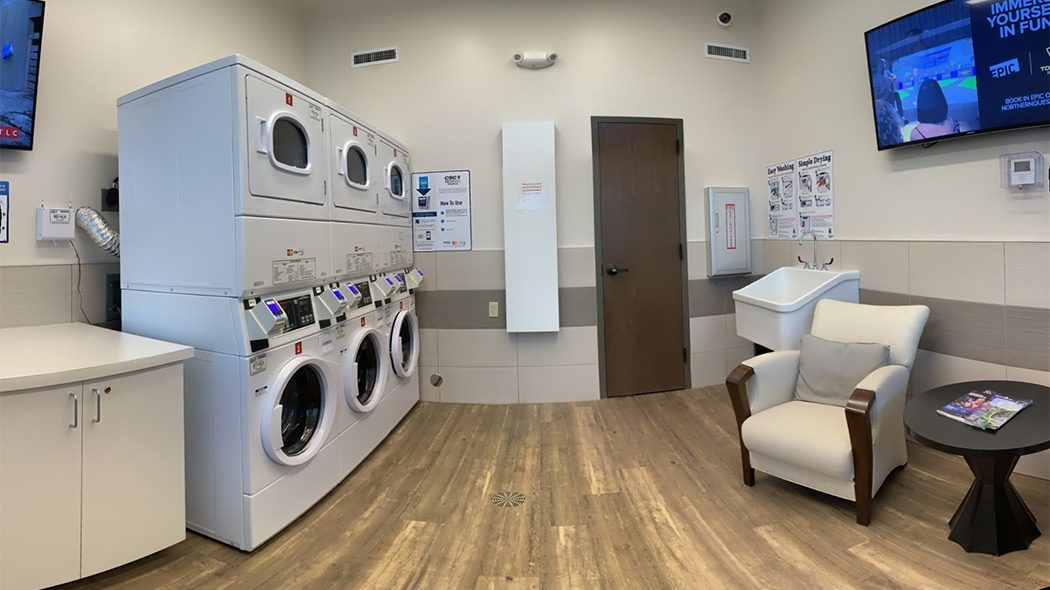 Cozy laundry facility at Northern Quest RV Resort with chairs and tv's to relax in while doing your laundry